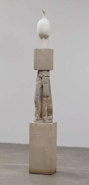 A white marble sculpture on a three-part limestone pedestal