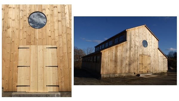 The exterior of a newly built, entirely wooden barn