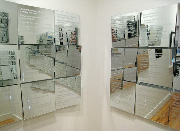 Square panels of mirrors with text etched into them