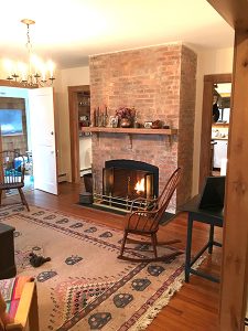 living room with working fireplace in the Woven Tale Press Hamptons retreat house