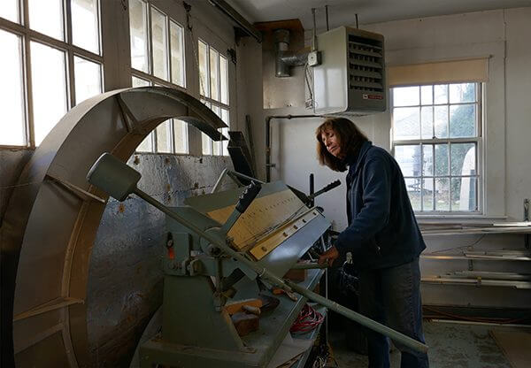 An artist working at a sculptor welding station