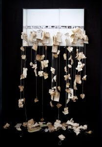 Sarah Nesbitt, Losing the Collection, 2011. Inventory tags sewn into pigmented inkjet print, 18” x 72” x 12” tableau