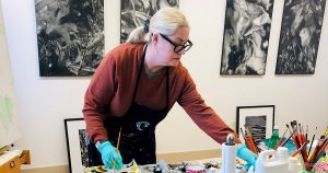 Nancy McTague Stock working in her studio