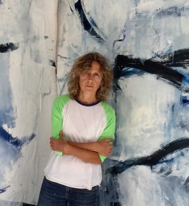 Emilia Dubicki in front of her painting
