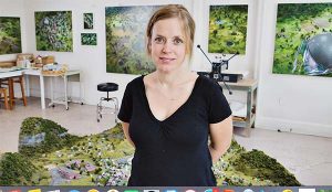 Amy Bennett in her studio, with her miniature models and paintings