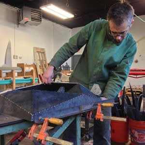 Joshua Enck working on metal in his studio