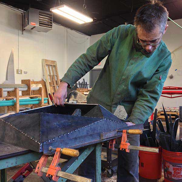 Joshua Enck sculpting in metal and wood