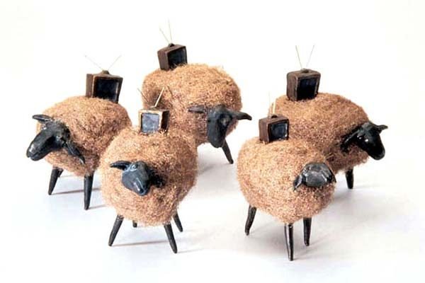 Sculpture of sheep with television sets on top of them