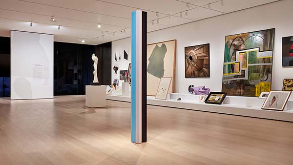 Installation view of sculptures, photography, and paintings at an exhibit in New York