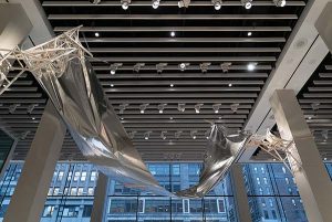 A mylar installation hanging between two posts