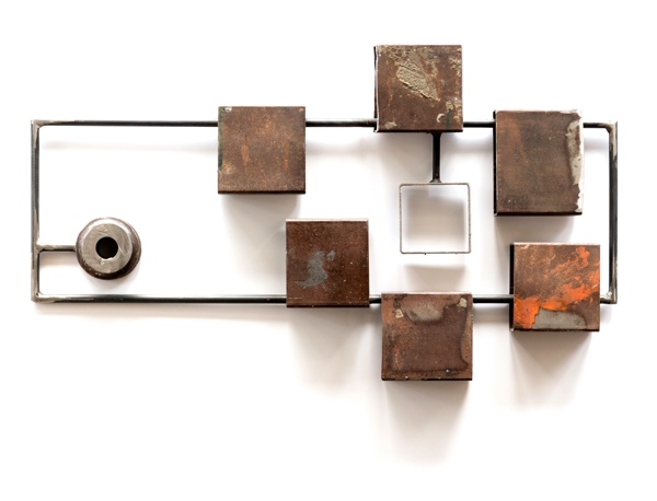 A steel sculpture installation of boxes and piping