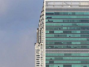 A photo of the Chrysler building behind another building