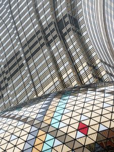 An abstract photo oof buildings with colored reflective window panels