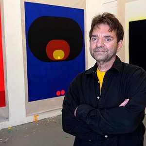 Painter Tom Martinelli poses with his work