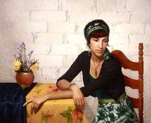 An oil painting of woman sitting at a kitchen table with a pot of drooping flowers