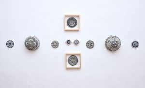 An installation of orb-shaped pieces in a t-shape