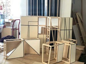 Woodwork in progress in sits on the floor of a studio