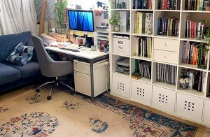 Desk corner of Rachael Wellisch's studio, mostly second-hand furniture finds, including this awesome rug.