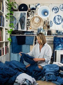 Rachael Wellisch In her home studio with textiles in various stages of being dyed for projects.